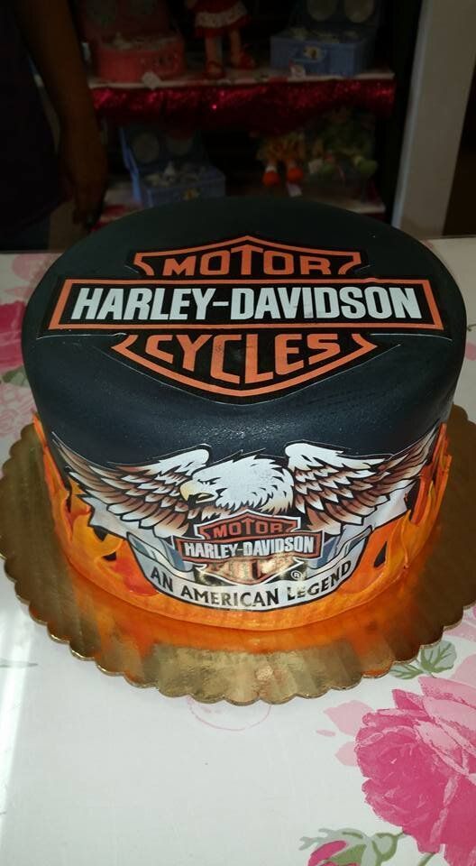 A harley davidson cake is sitting on a table.