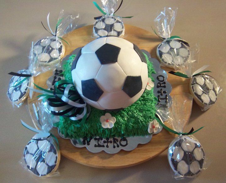 A cake with a soccer ball on top of it