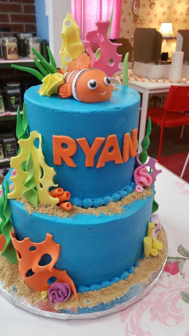 A blue cake with the name ryan on it
