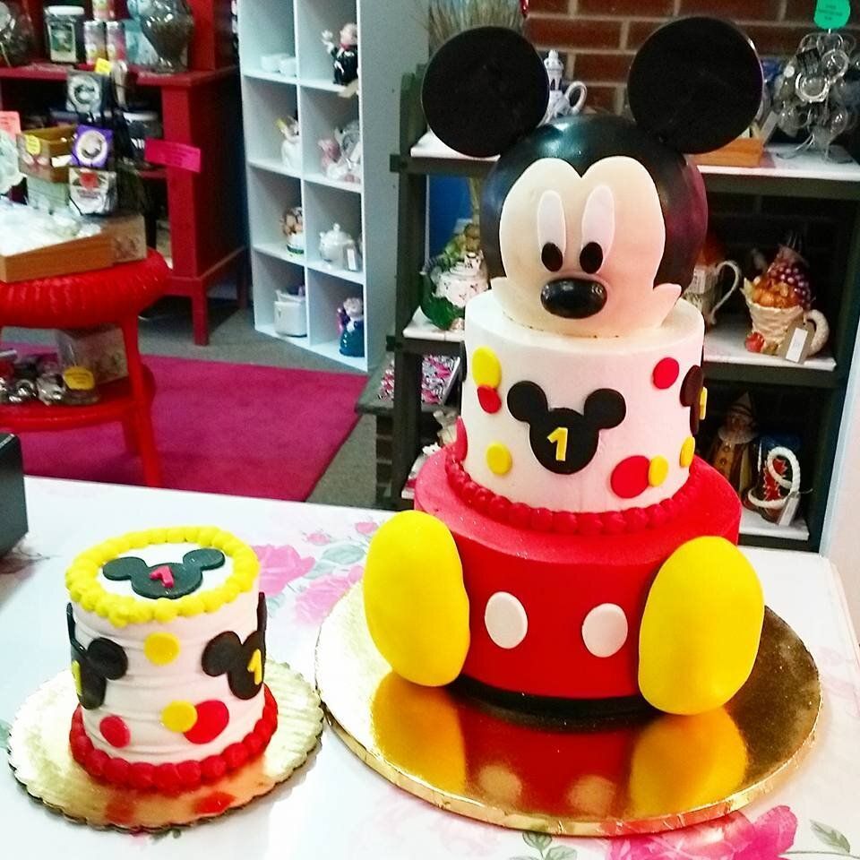 Two mickey mouse cakes are sitting on a table