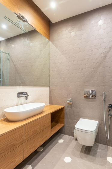 A bathroom with a sink , toilet and mirror.