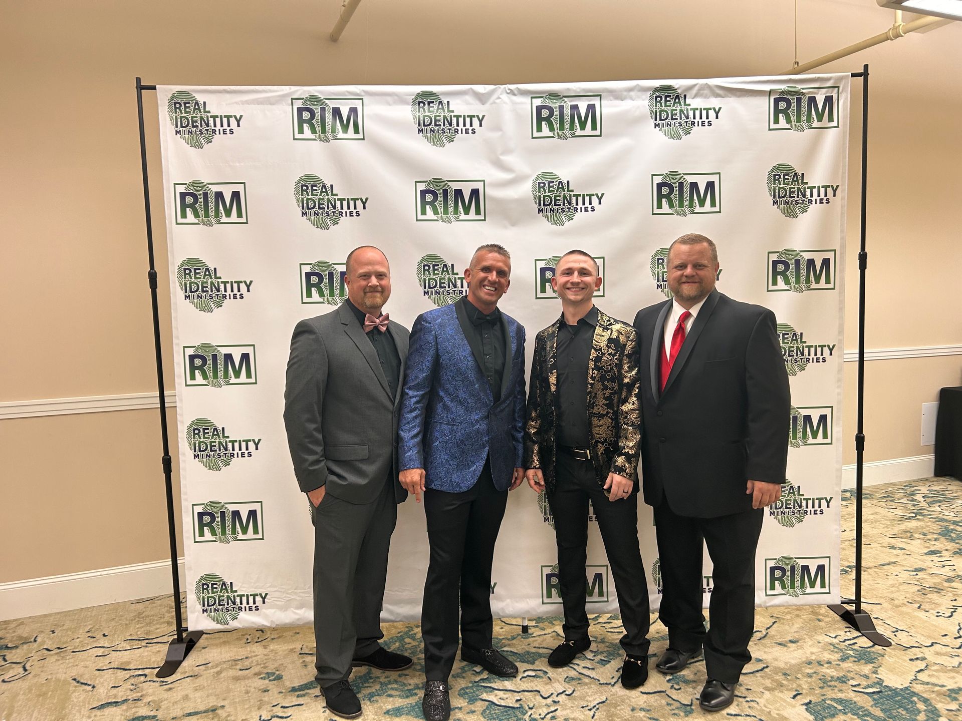 Real Identity Ministries sober soiree event photo shoot - group of men by the photo wall