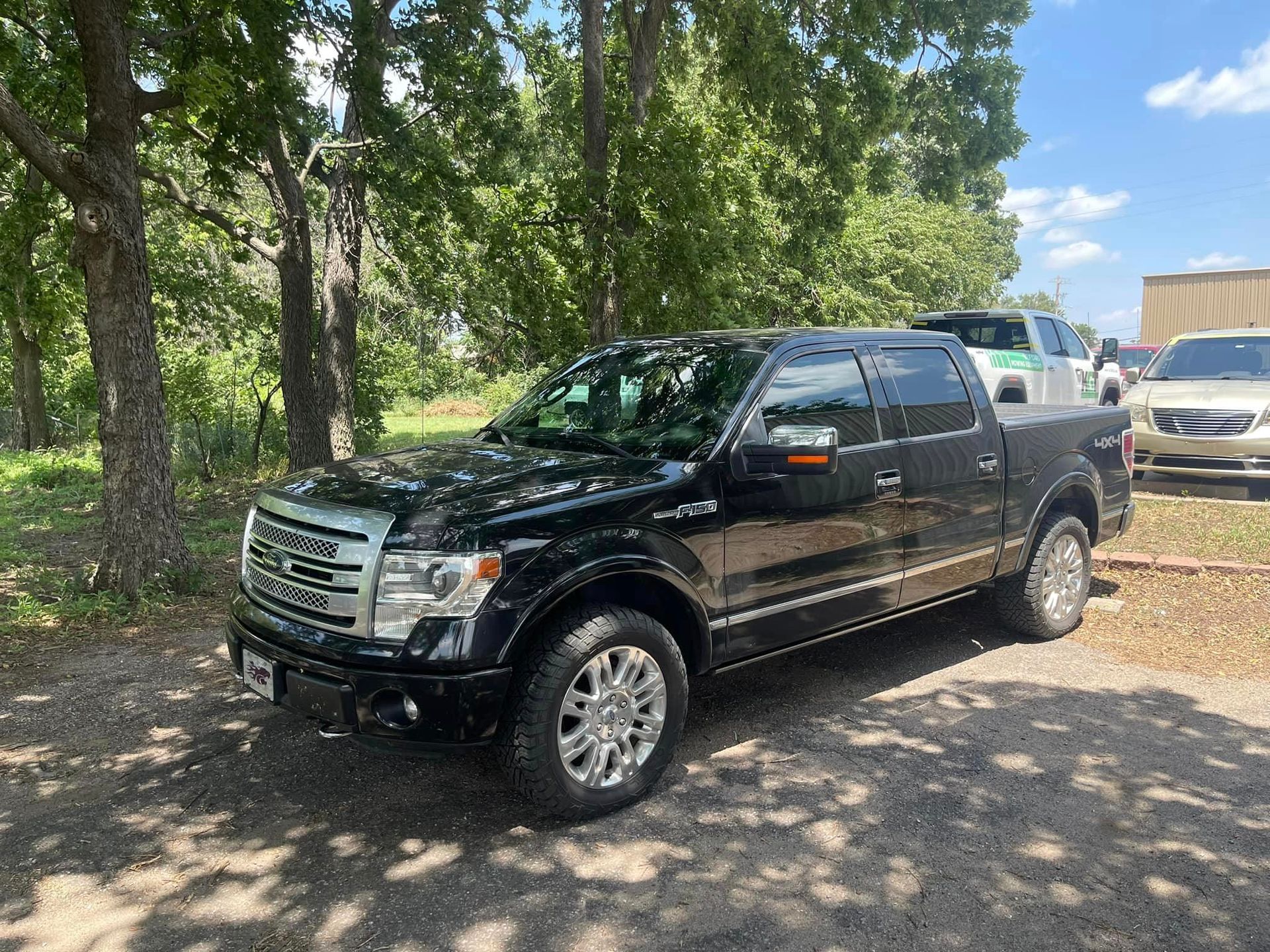 A Black Ford F150 Truck Is Parked in A Parking Lot Next to Trees | Wichita, KS | ICT Pros Window