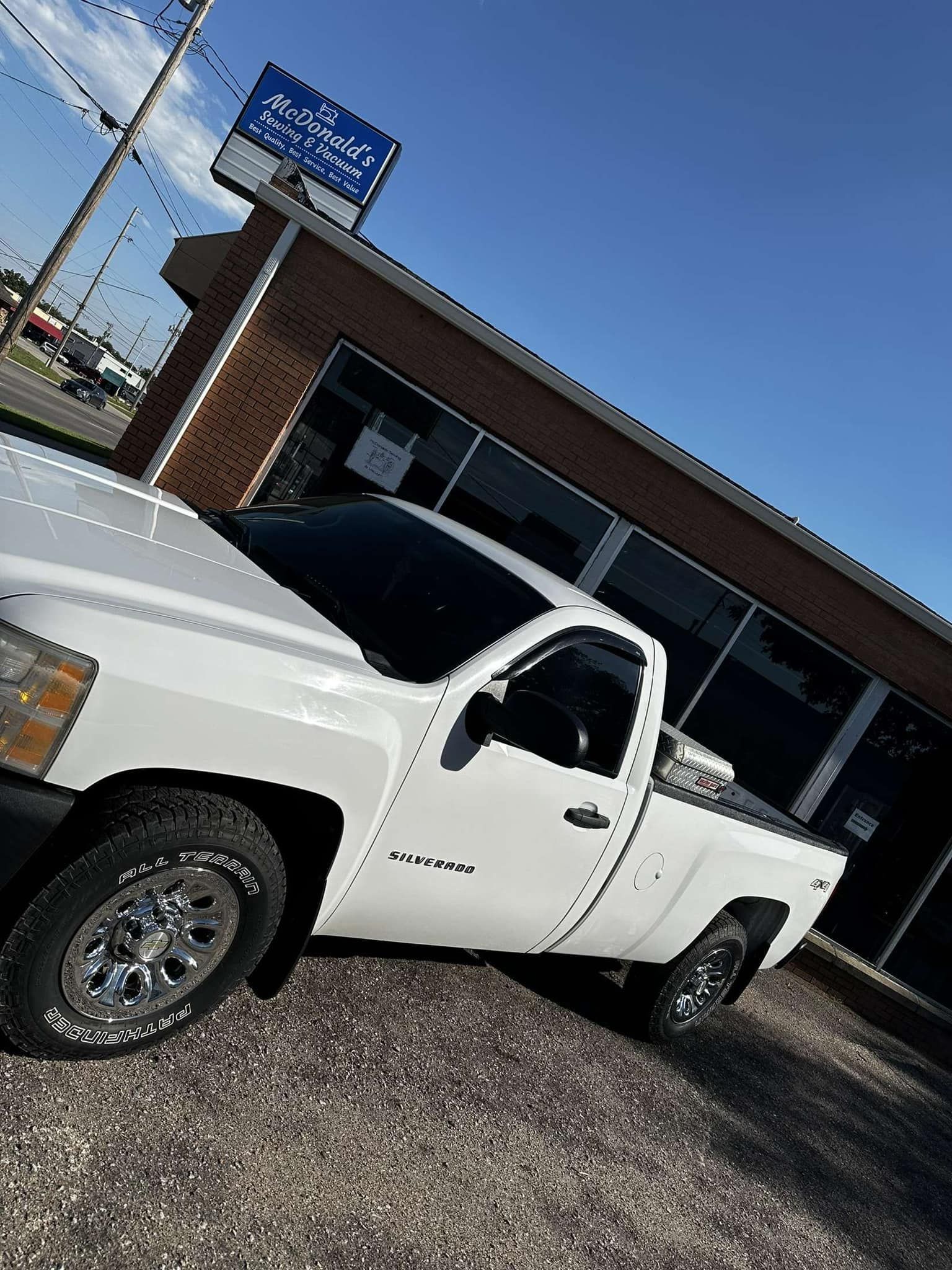 A White Truck Is Parked in Front of A Building | Wichita, KS | ICT Pros Window