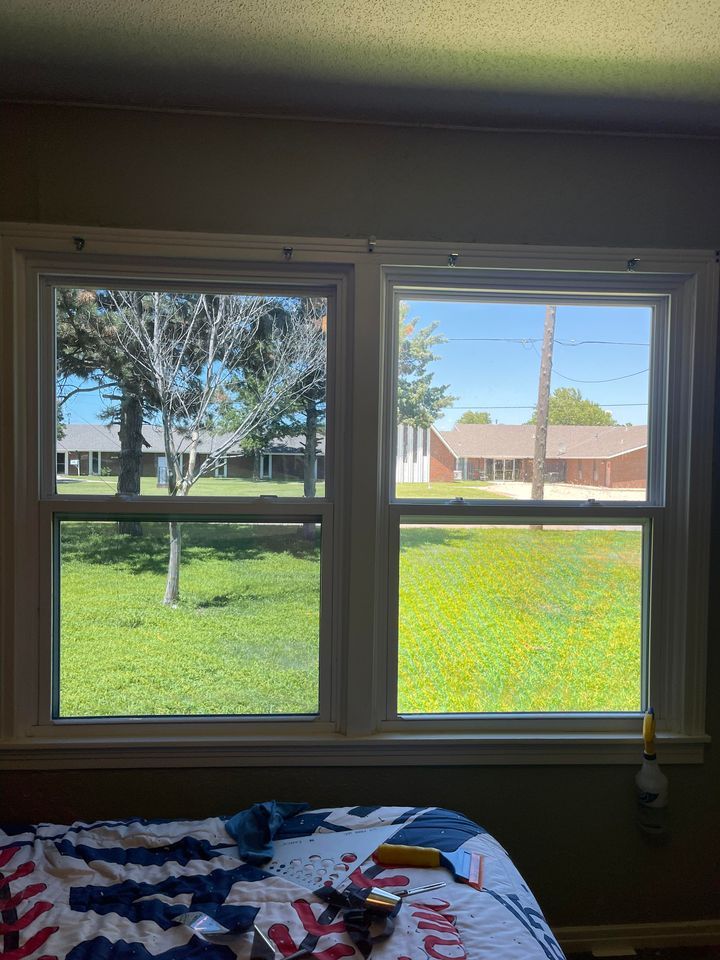 A Bedroom with Two Windows and A Bed with A View of A Yard | Wichita, KS | ICT Pros Window