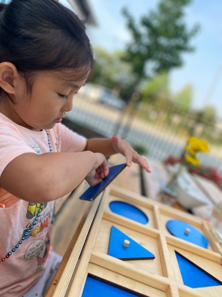 An IMA student works with the Geometric Cabinet. 