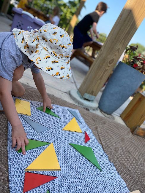A Montessori child works with the Constructive Triangles 