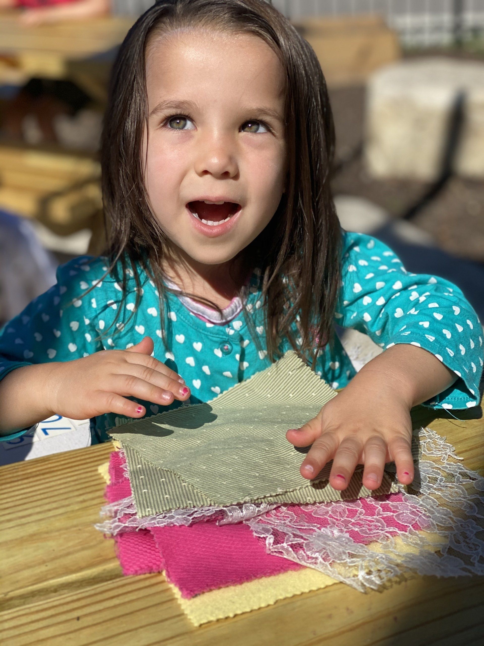 A Kid playing with pieces of cloth
