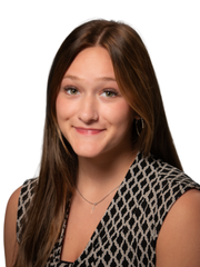 A man in a suit and tie is smiling for the camera.