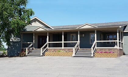 A funeral home with a black awning over the door