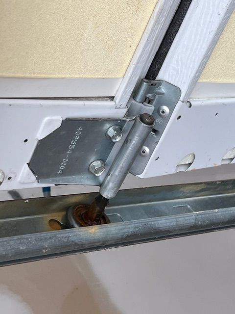 Worn garage door roller causing noise and vibration