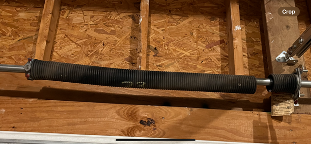 Broken garage door torsion spring on shaft