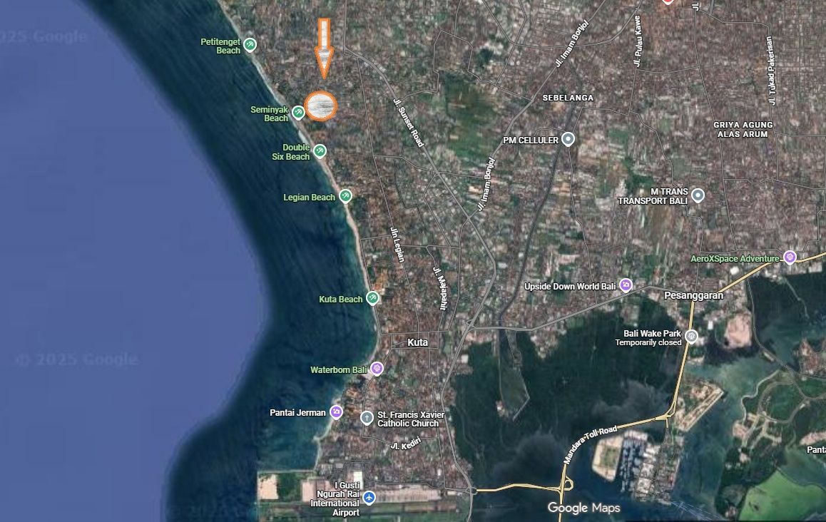 Satellite view of a SW Bali with an arrow pointing inland, near a beach and ocean.