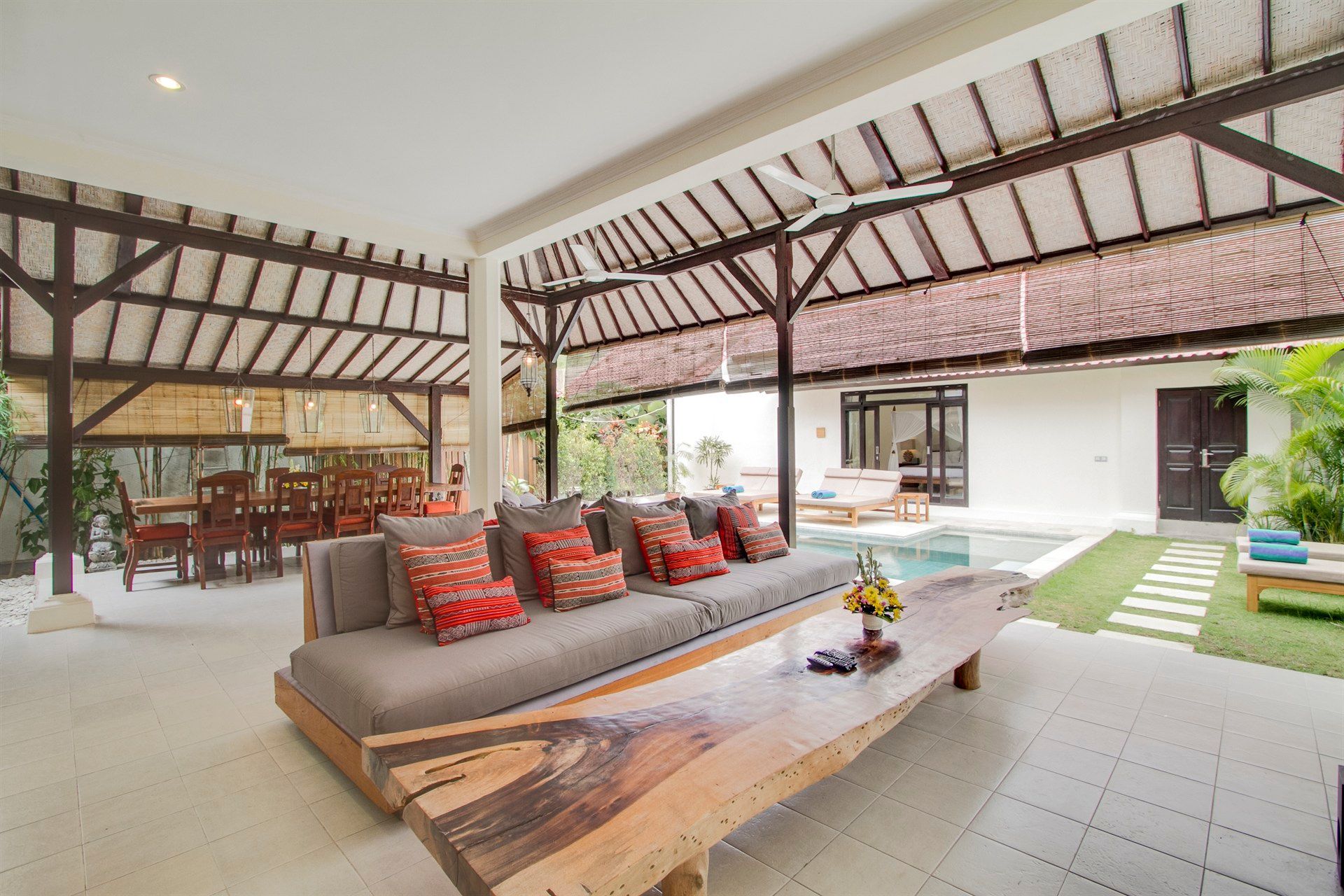 There is a large wooden table in the middle of the living room.