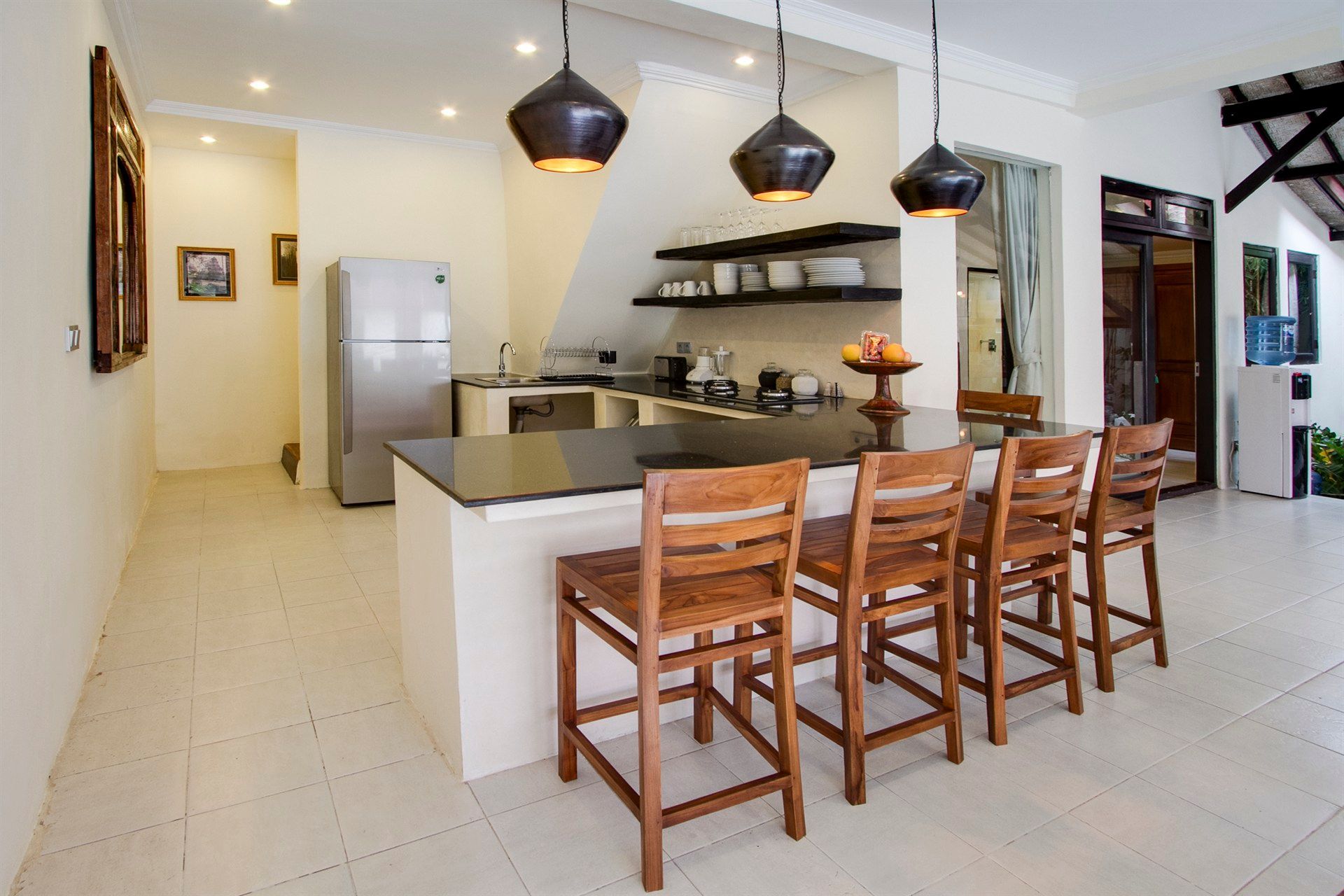 A kitchen with a table and chairs and a refrigerator