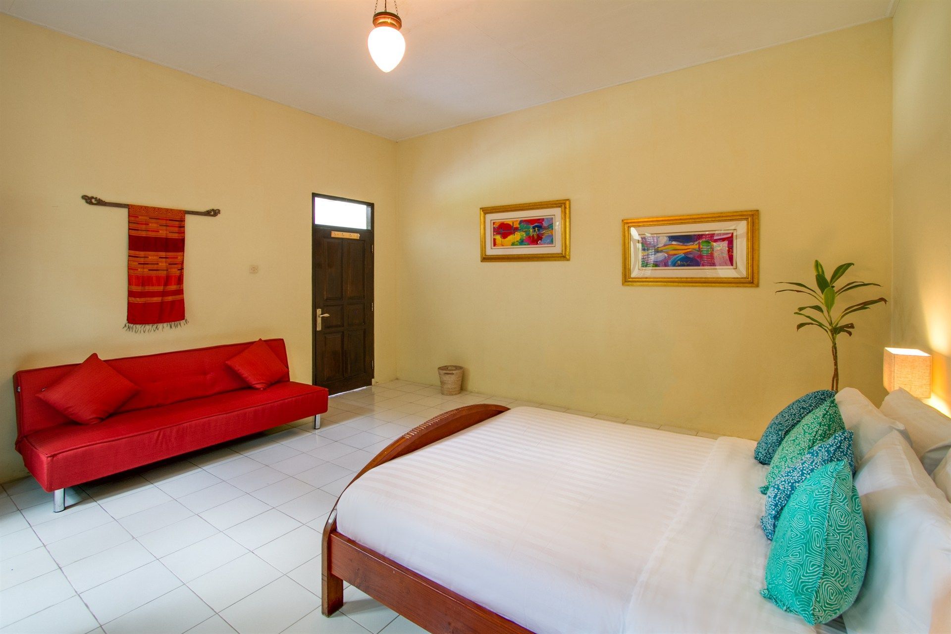 There is a bed and a couch in the room.