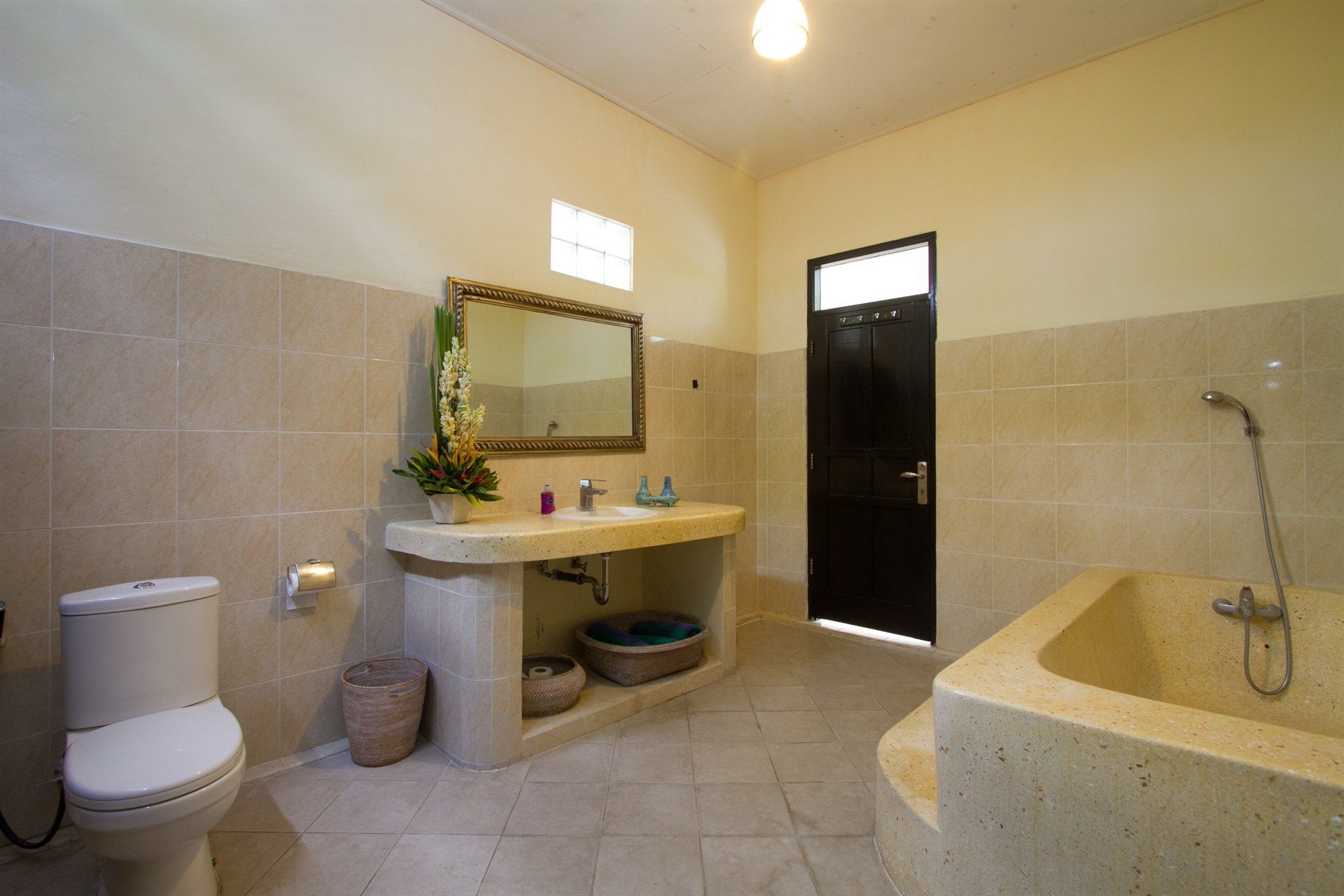 A bathroom with a toilet , sink and bathtub.