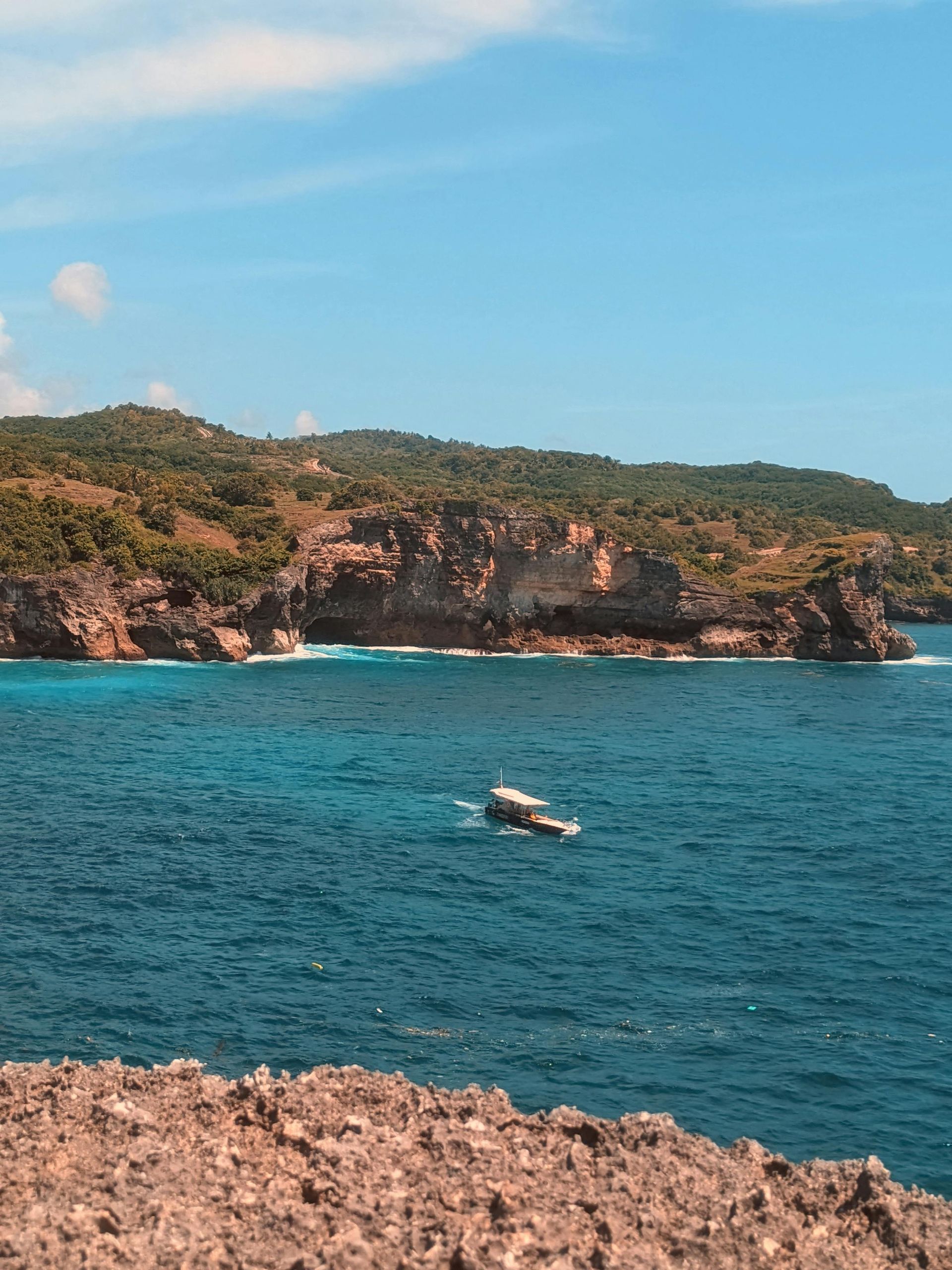 A boat is floating on top of a large body of water.