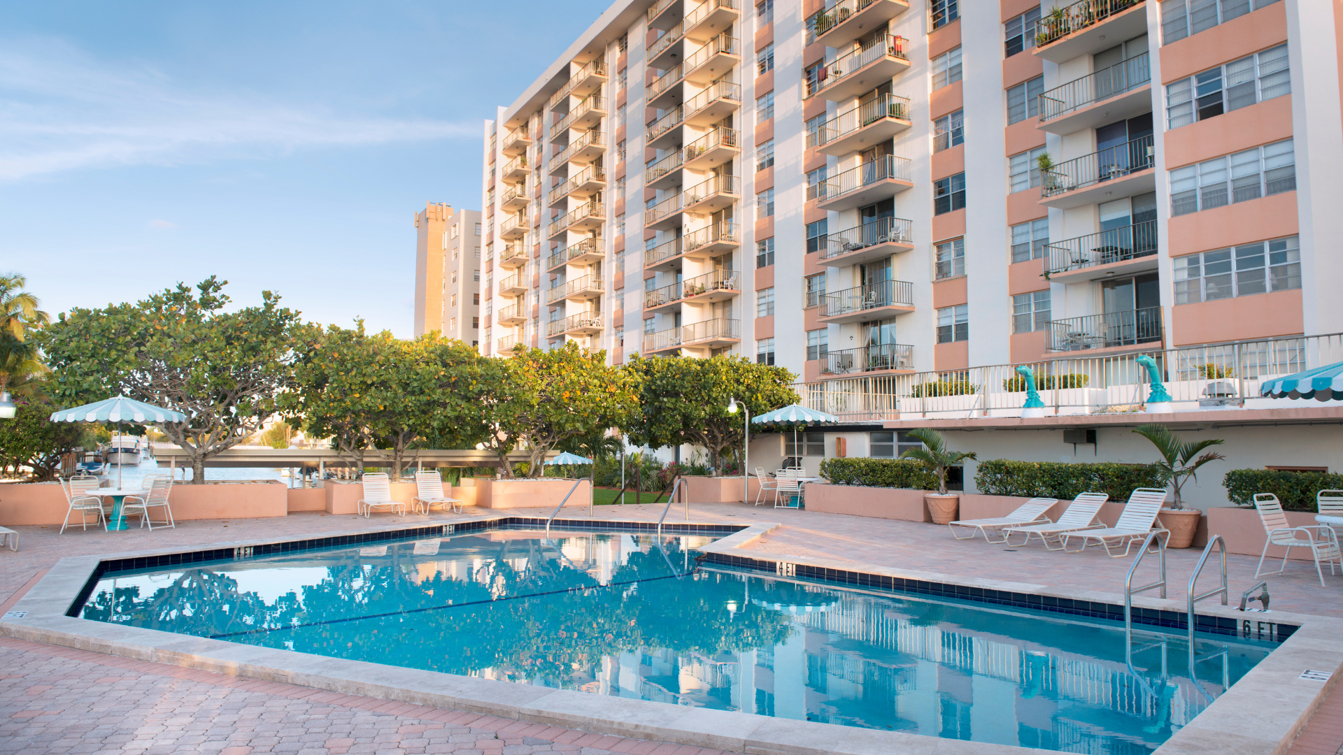 A large swimming pool in front of a tall building