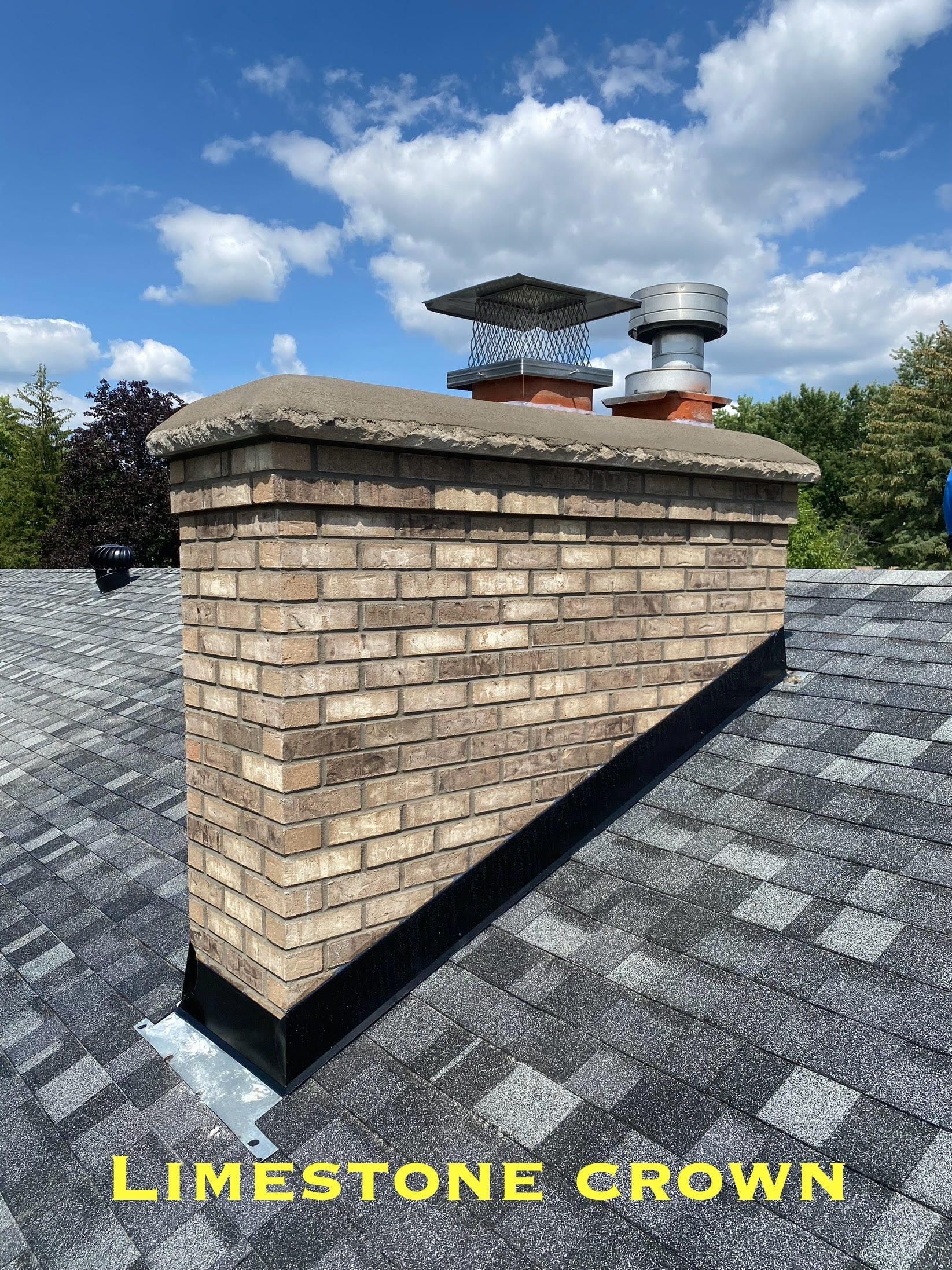 A brick chimney on top of a roof with a limestone crown.