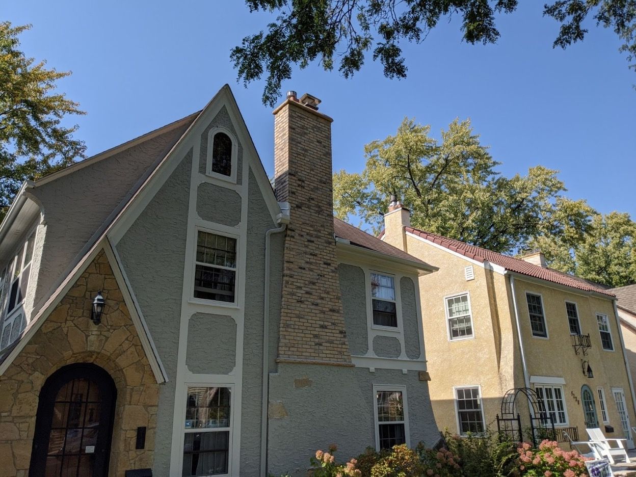 A house with a chimney on the side of it