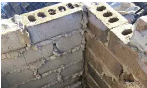 A close up of a brick wall with a hole in it.