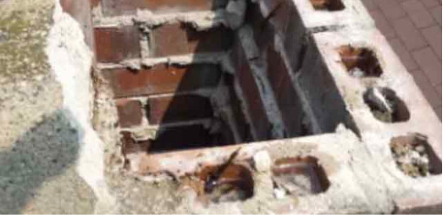 A close up of a brick wall with a hole in it.