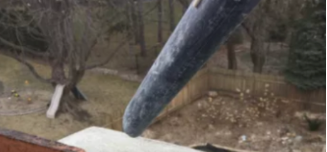 A person is cutting a piece of wood with a saw.