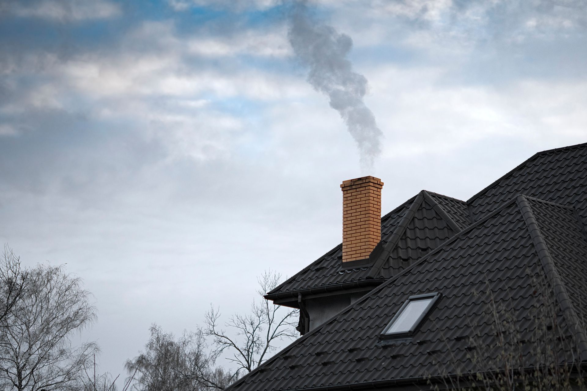 A professional inspecting and repairing a chimney with visible cracks and efflorescence in St. Micha