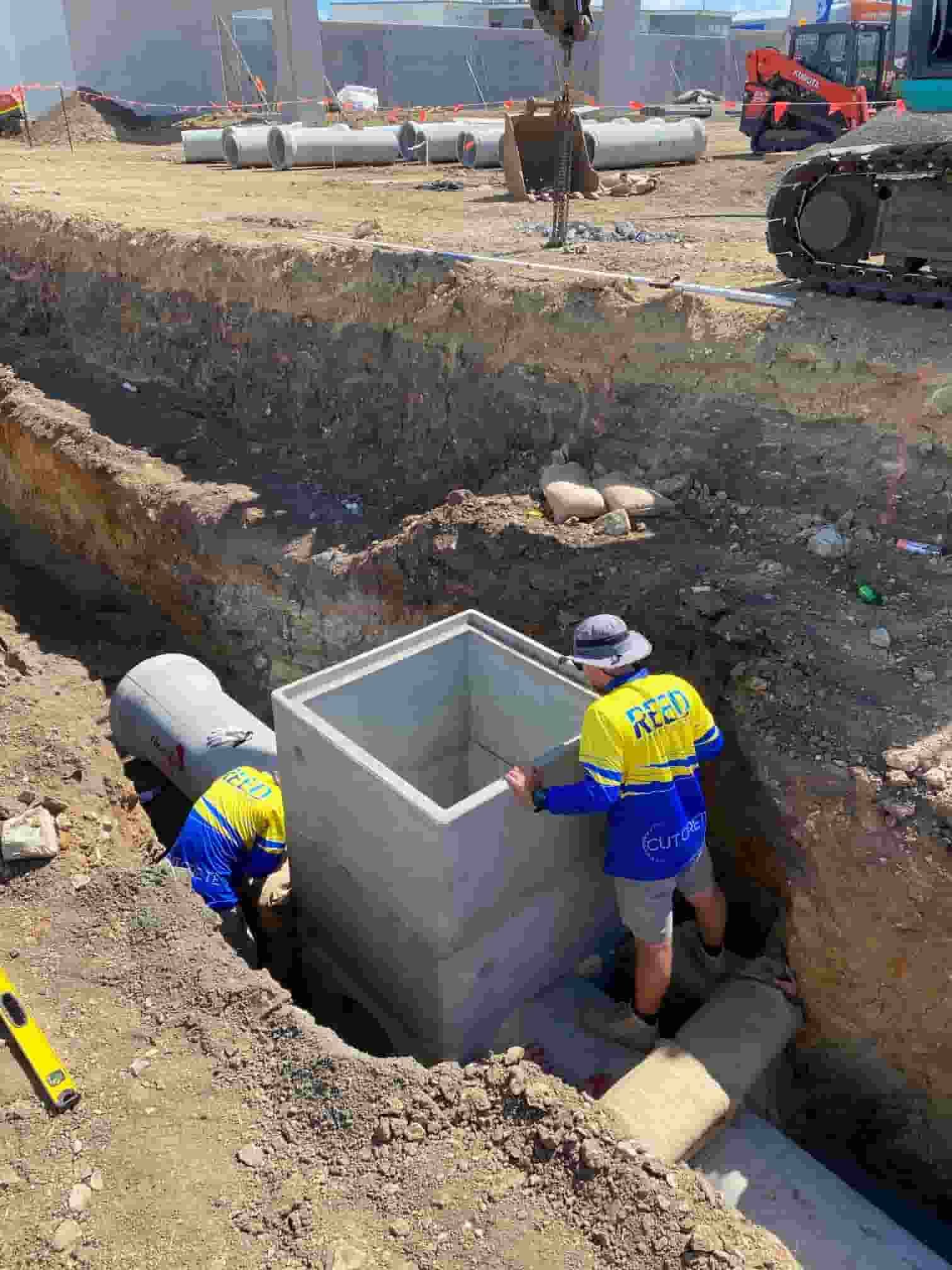 A Group of Construction Workers Are Working on a Construction Site — Reed Plumbing Industries in Proserpine, QLD