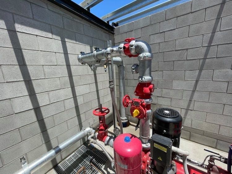 A Room With a Lot of Pipes and Valves on It — Reed Plumbing Industries in Mackay, QLD