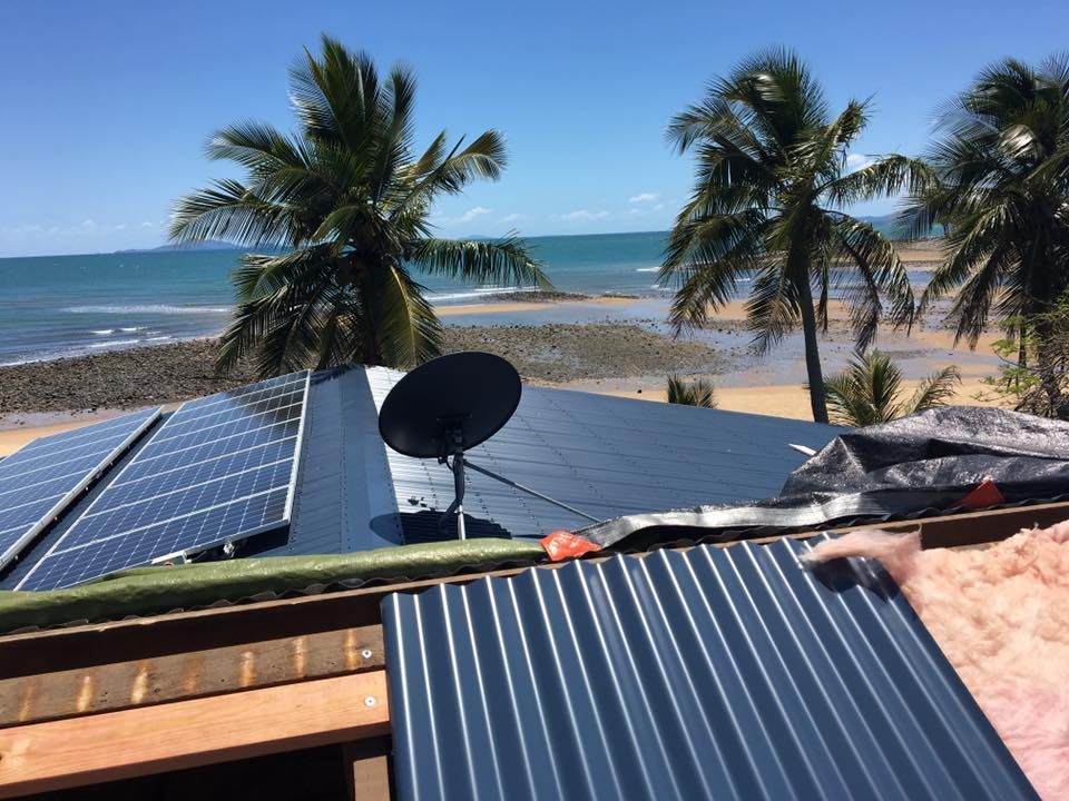 A Corrugated Metal Roof With an Antenna on Top of It — Reed Plumbing Industries in Mackay, QLD