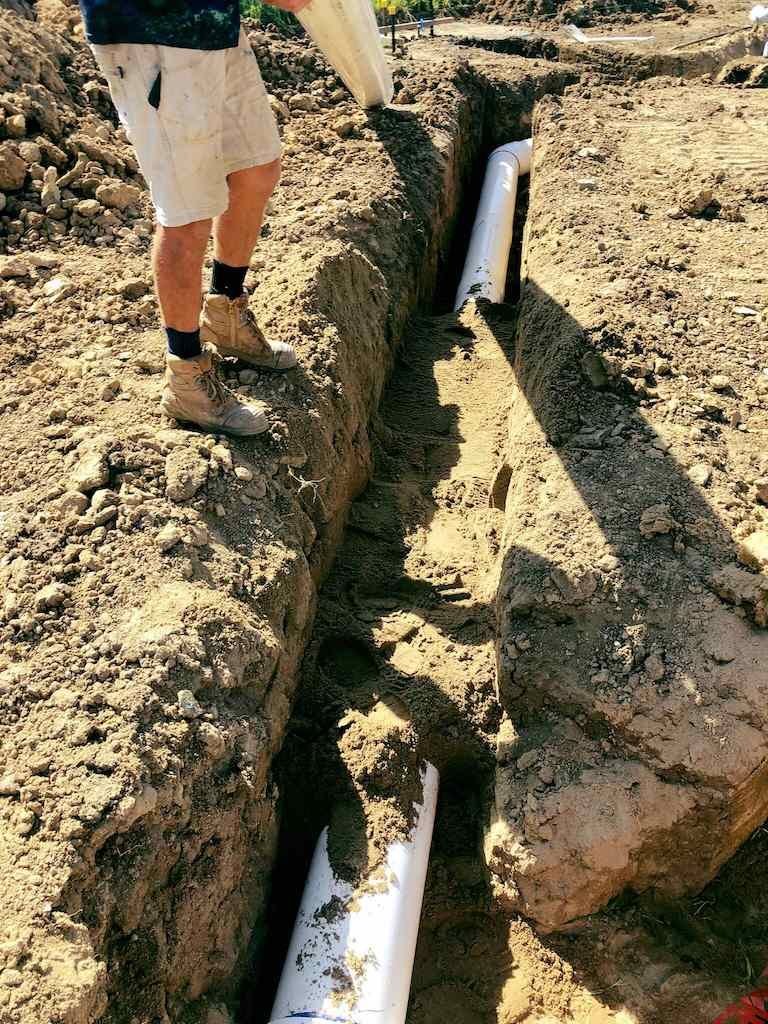 A Group of Construction Workers Are Digging in the Dirt — Reed Plumbing Industries in Mackay, QLD