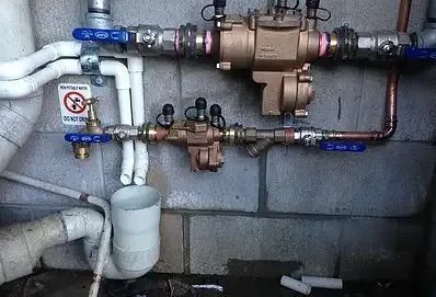 A Bunch of Pipes Are Connected to a Wall — Reed Plumbing Industries in Rural View, QLD