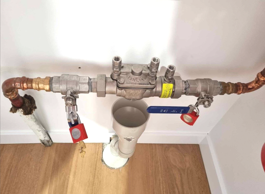 A close up of a copper pipe with a valve attached to it — Reed Plumbing Industries in Mackay, QLD