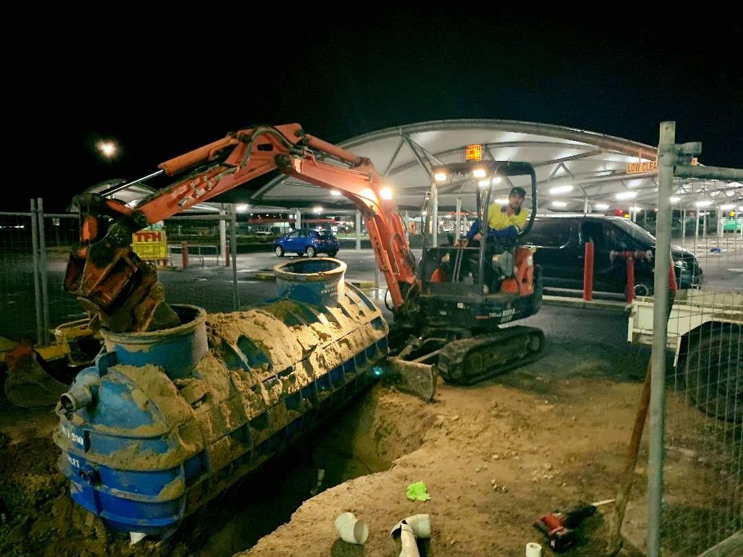 A Group of Construction Workers Are Doing Industrial Work in the Dirt — Reed Plumbing Industries in Mackay QLD