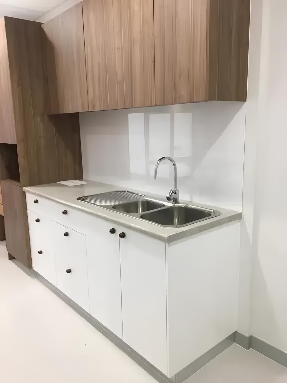 A Kitchen With Two Sinks and Wooden Cabinets — Reed Plumbing Industries in Mackay, QLD