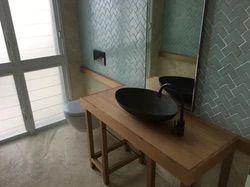 A New Bathroom  With a Toilet, Vanity, Basin and a Window — Reed Plumbing Industries in Mackay, QLD