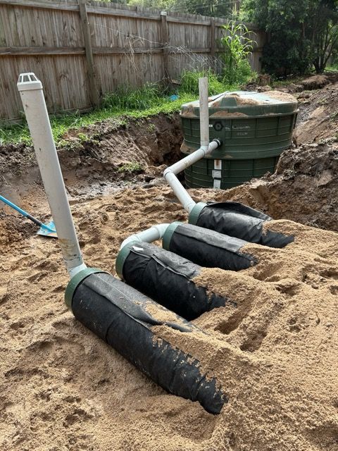 A Green Septic Tank is Being Installed in a Hole in the Ground — Reed Plumbing Industries in Mackay, QLD