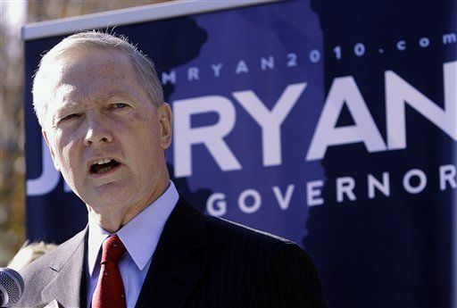 A man stands in front of a sign that says ryan governor