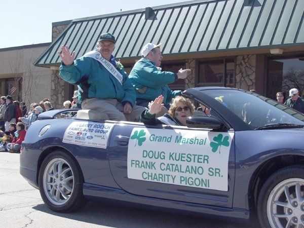 A blue car with a sign that says grand marshal