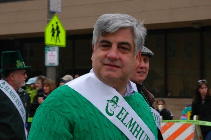 A man wearing a sash that says elmhurst on it