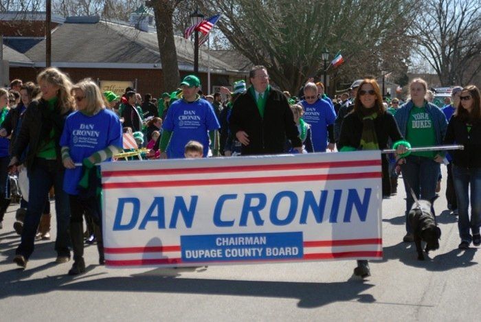 A group of people marching with a banner that says dan cronin