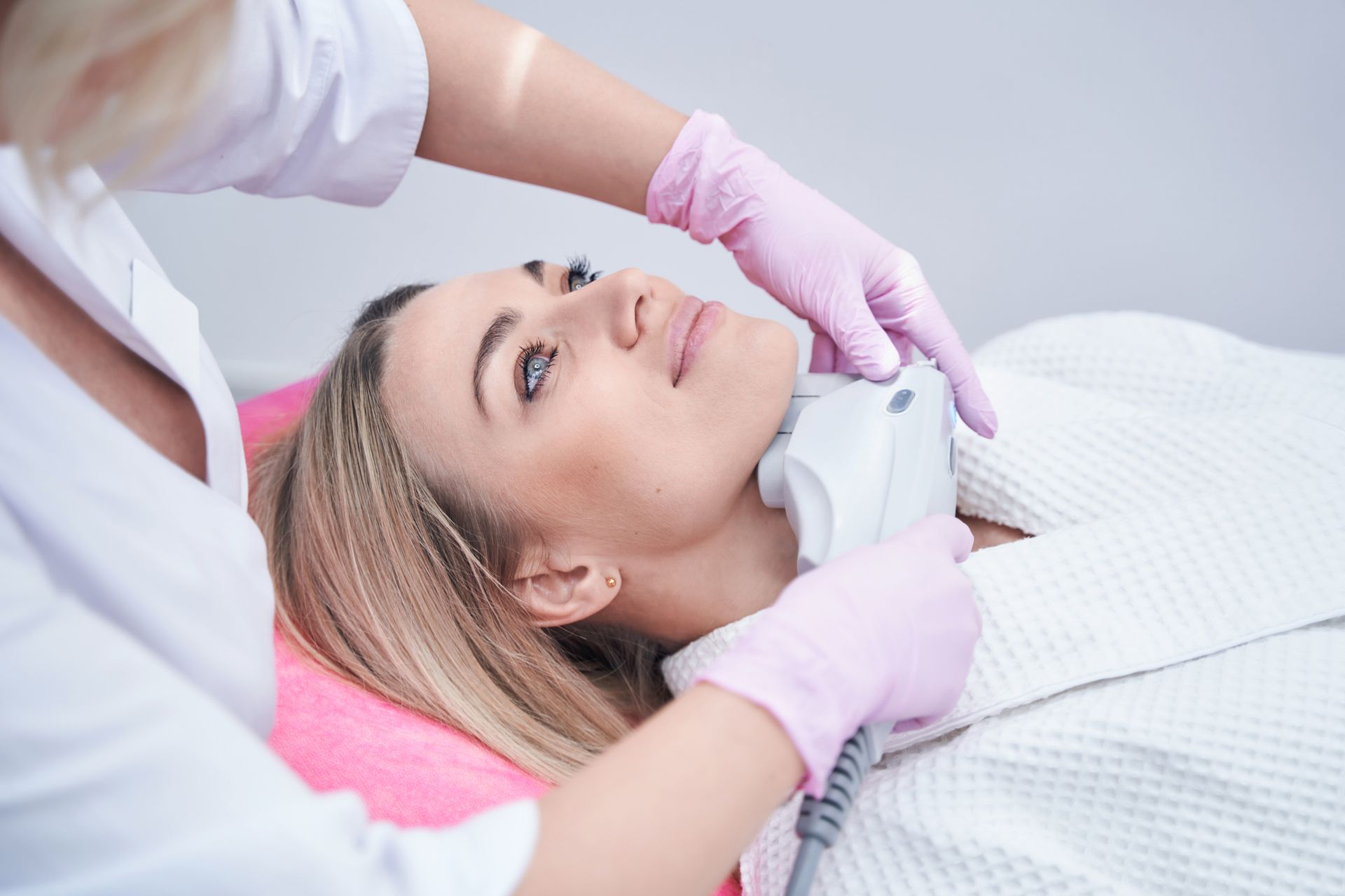 A female patient undergoing a non-surgical skin-tightening procedure