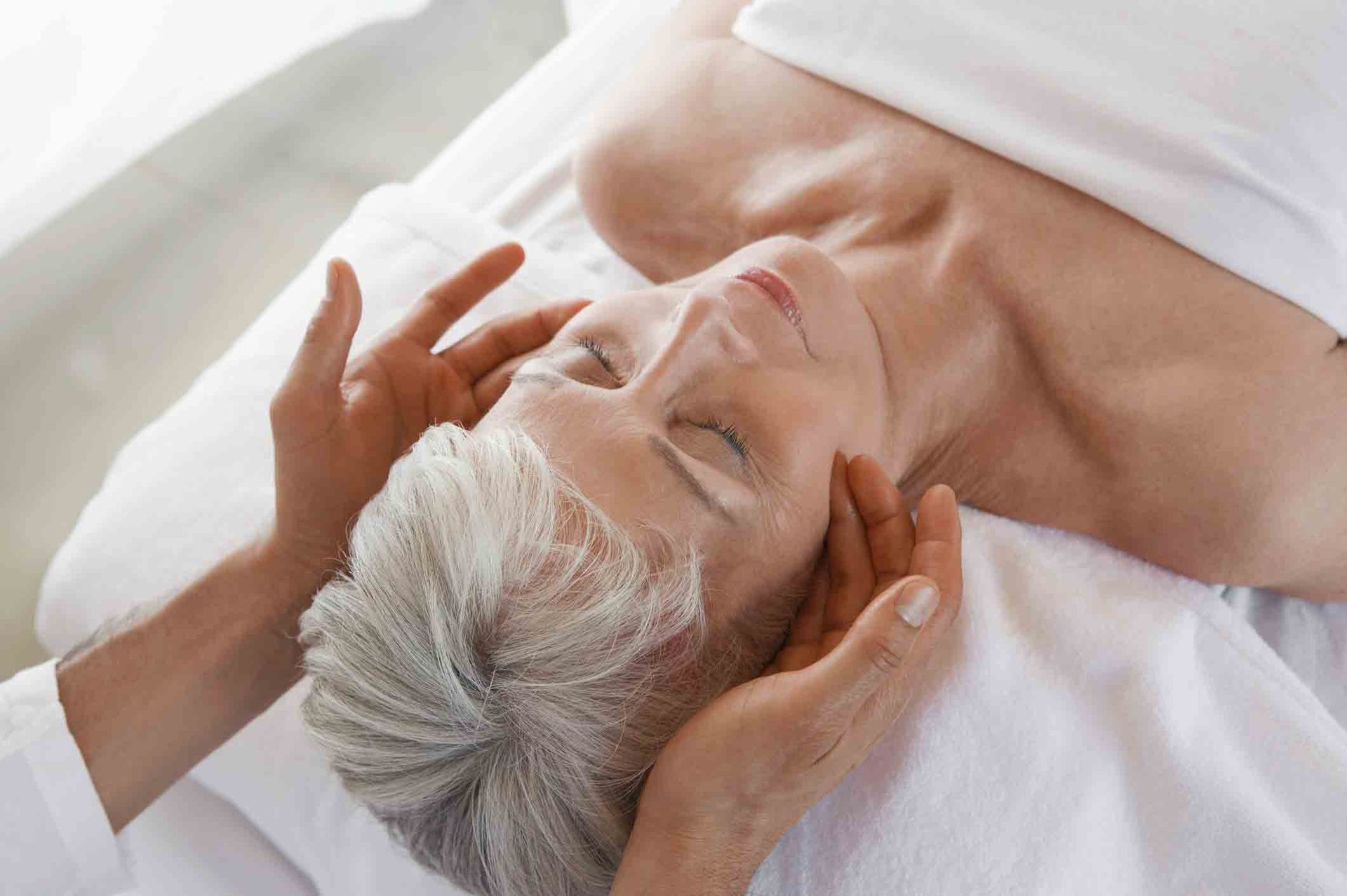 Woman receiving a relaxing facial massage at Ponte Vedra Vein Institute in Jacksonville, FL, 