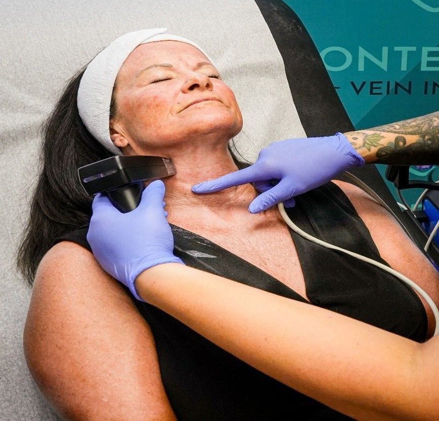 A woman in a bed receiving treatment.