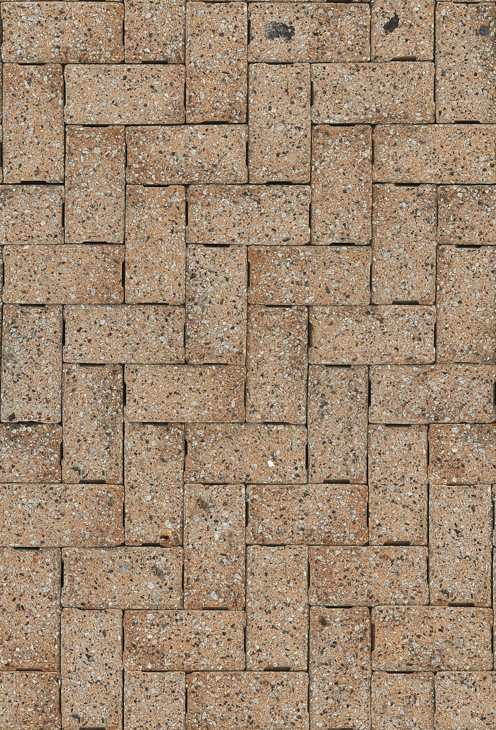 Night shot of a house with landscape lighting illuminating the entrance pathway. Two people stand near the door.