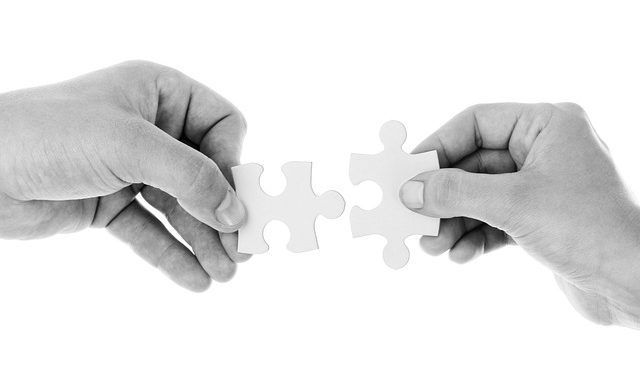 Two People Are Holding Puzzle Pieces - Columbia, SC - Custom Assurance Placements