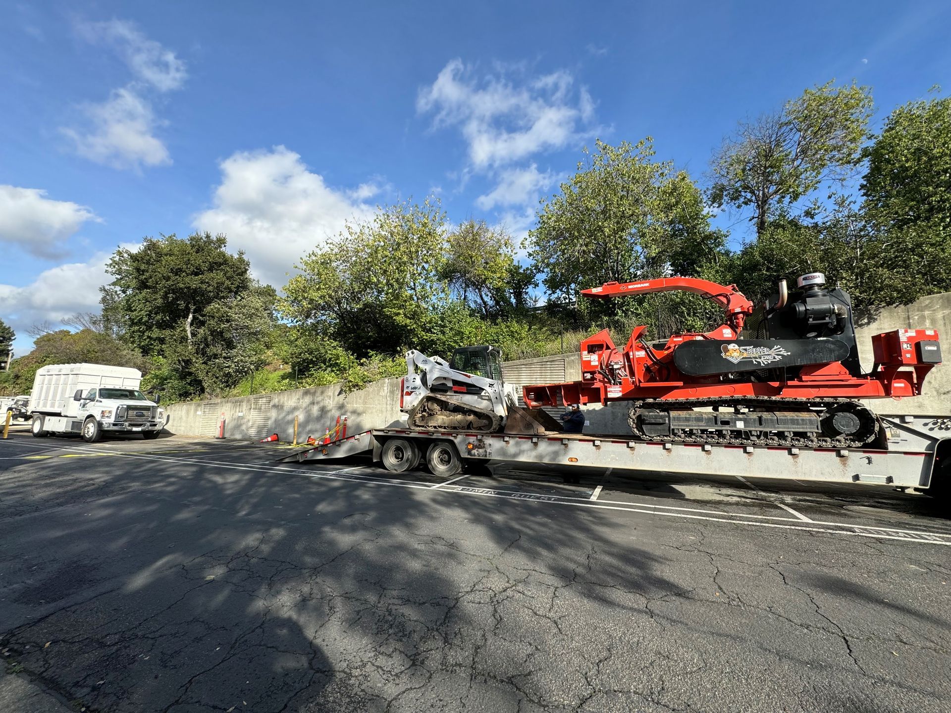A yellow excavator is sitting on top of a pile of dirt.