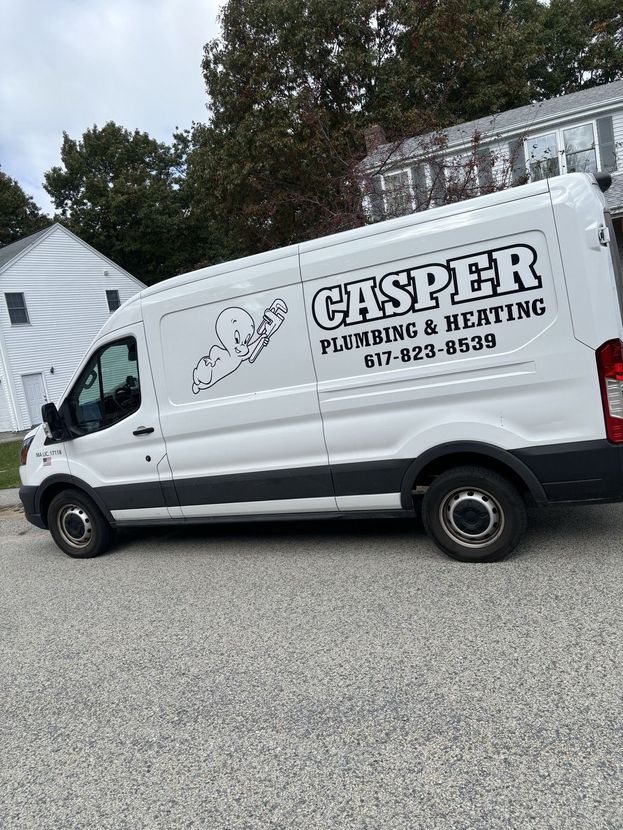 A white Casper Plumbing & Heating work van parked on a gravel surface next to a white house.